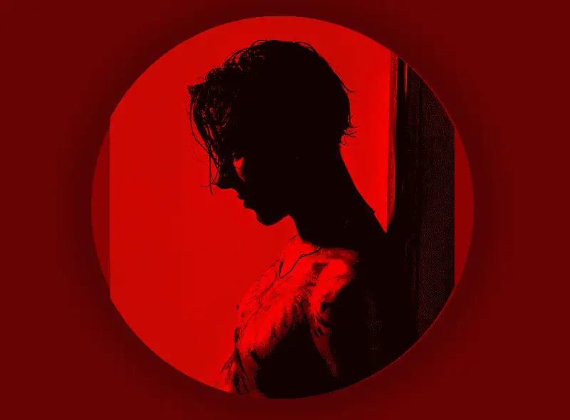 Silhouette in red light — history of gloryholes